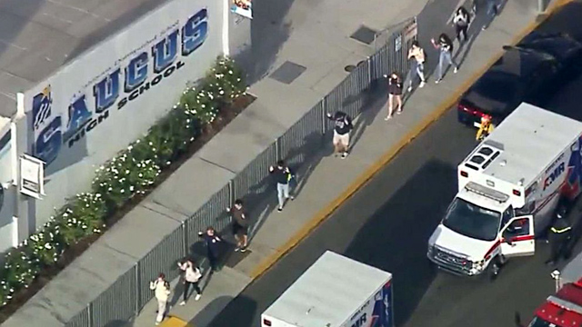 Students file out of Saugus High School after a reported shooting incident