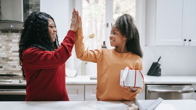 Photo of mother and daughter hitting 'high five'