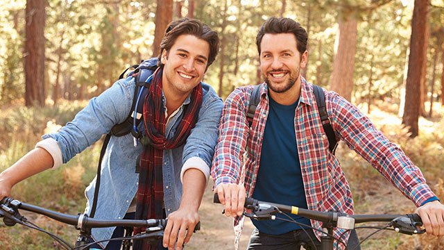 Gay couple riding bikes