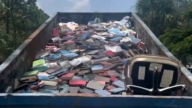 LGBTQ books in dumpster at New College of Florida (screen cap)
