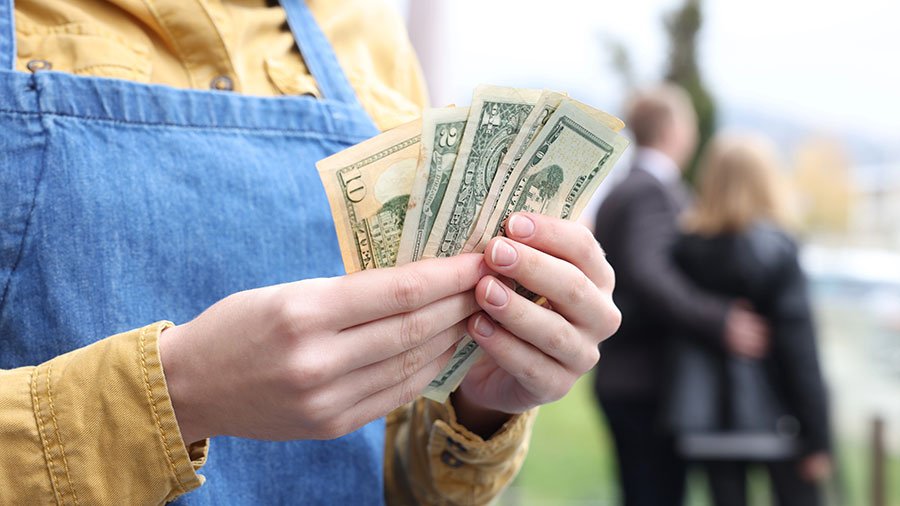 Waitress holding tips - will Trump's 'no taxes on tips' save her much?