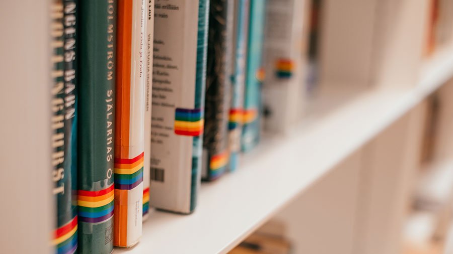 Library shelf featuring LGBTQ books